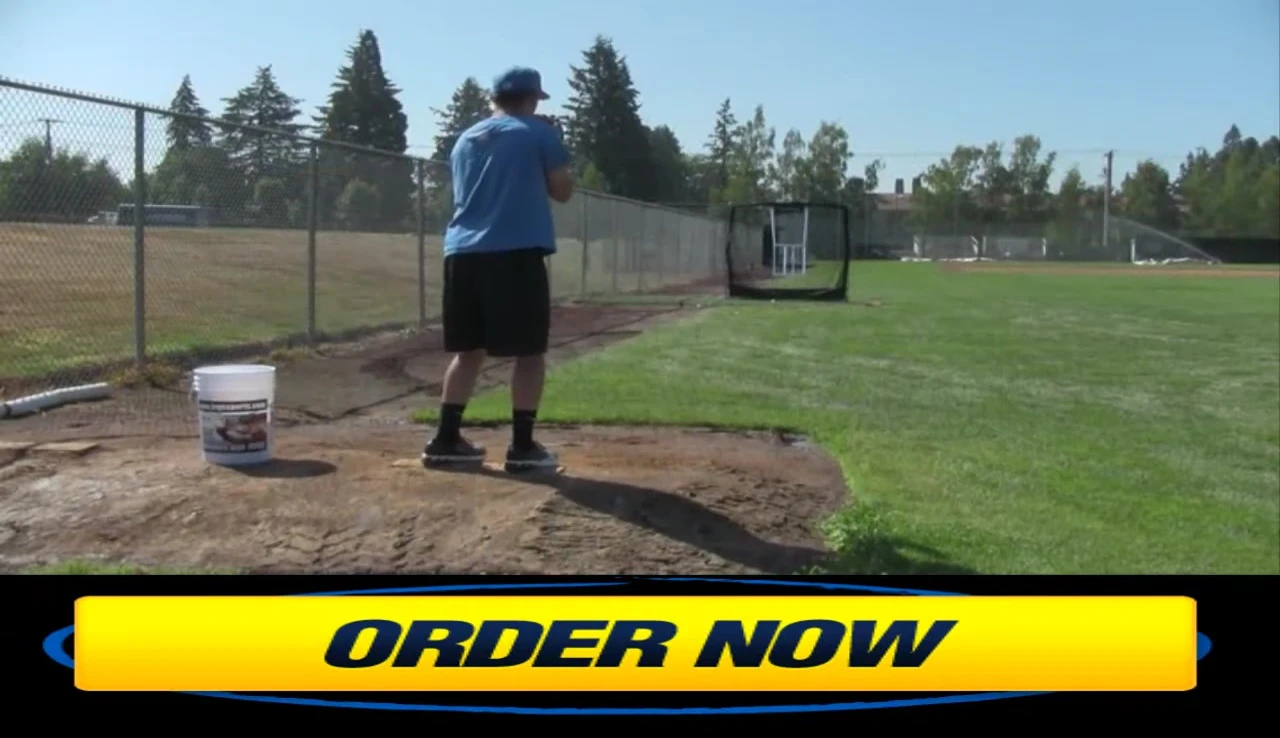 Jacob demonstrating the use of the Jugs Travel Screen for pitching practice.