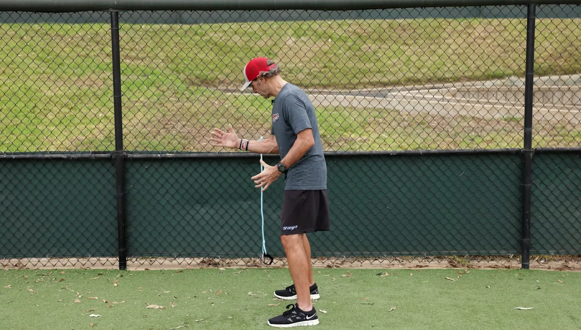 Close-up of the instructor's relaxed arm and hand position