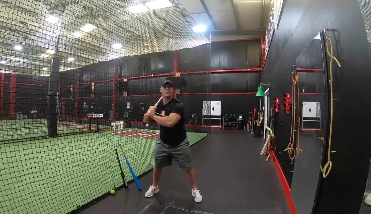 Baseball player performing the drill in front of a mirror.