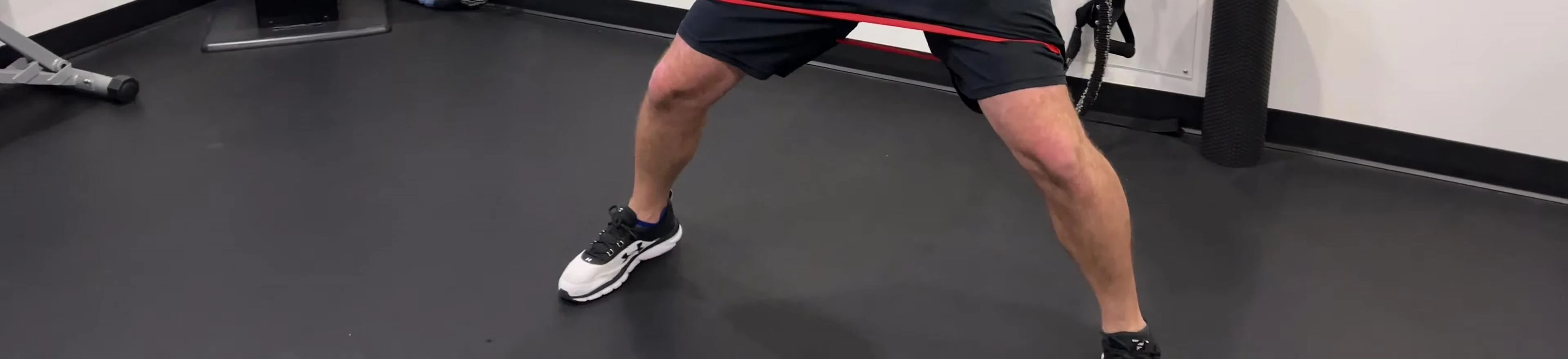 Trainer demonstrating the use of loop bands in a group fitness setting