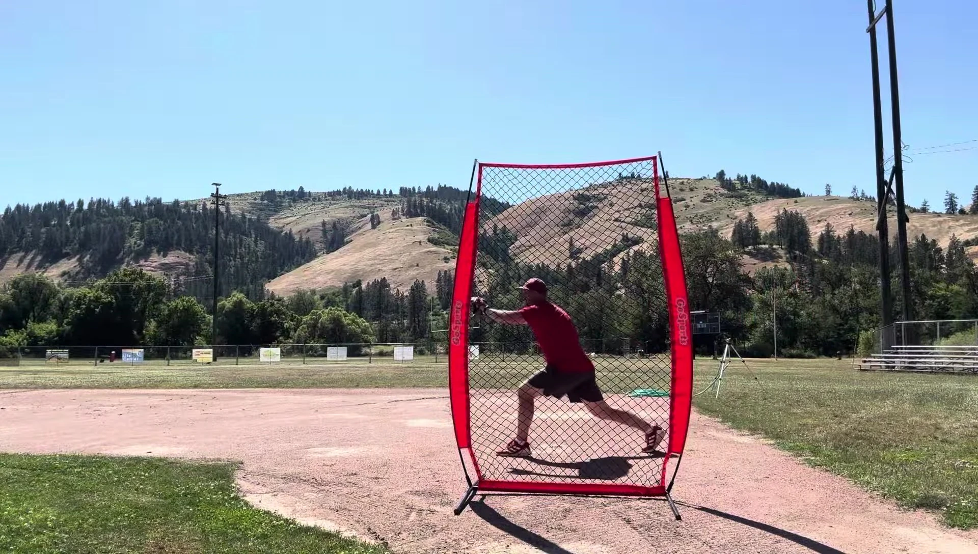 The coach throwing baseballs at the I-screen during the field test.