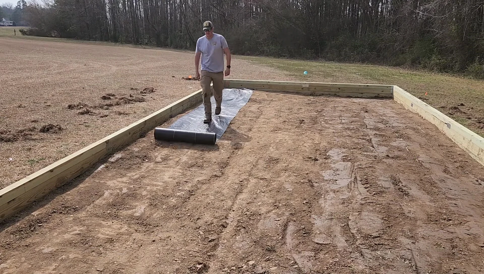 Securing the weed barrier fabric.