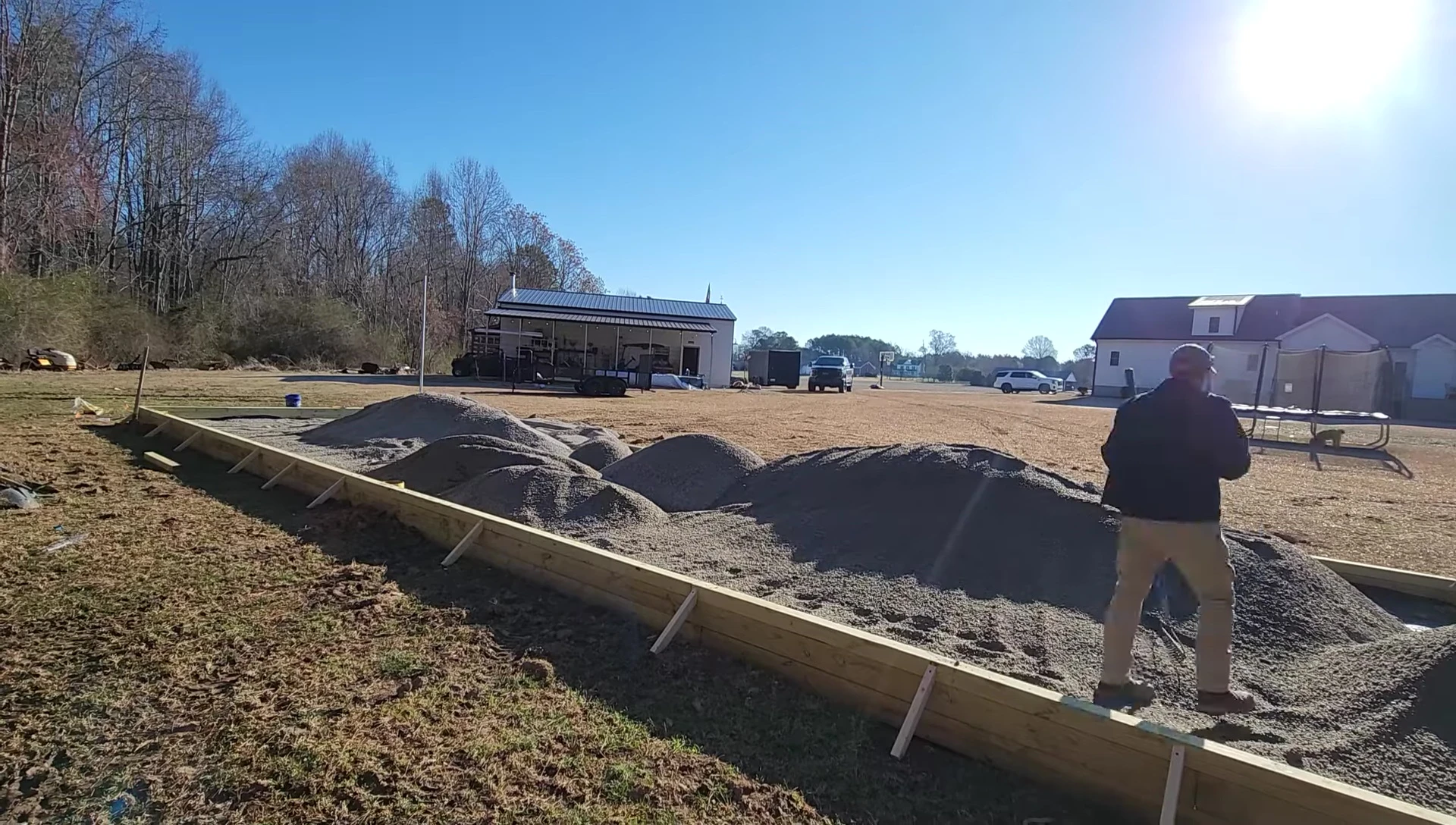 Gravel being spread and compacted.