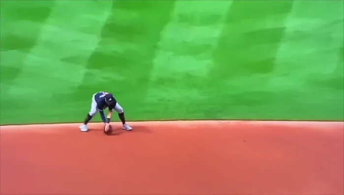 Funneling and Grip: Funnel the ball to the middle of your body, bringing your elbows out and thumbs up. This secure grip enables a smooth transfer to the throw.