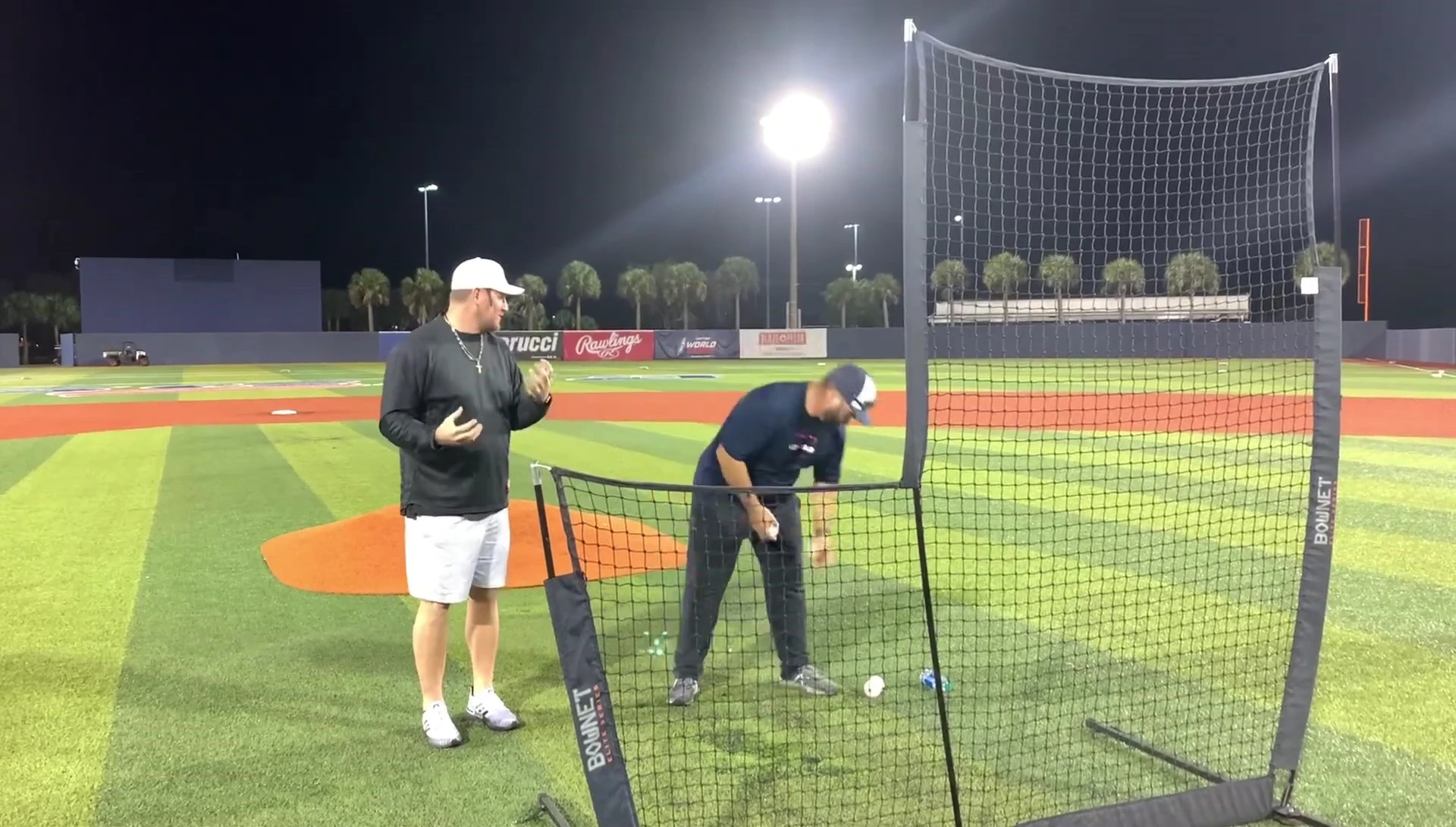 Coach demonstrating his preferred grip and ball placement.