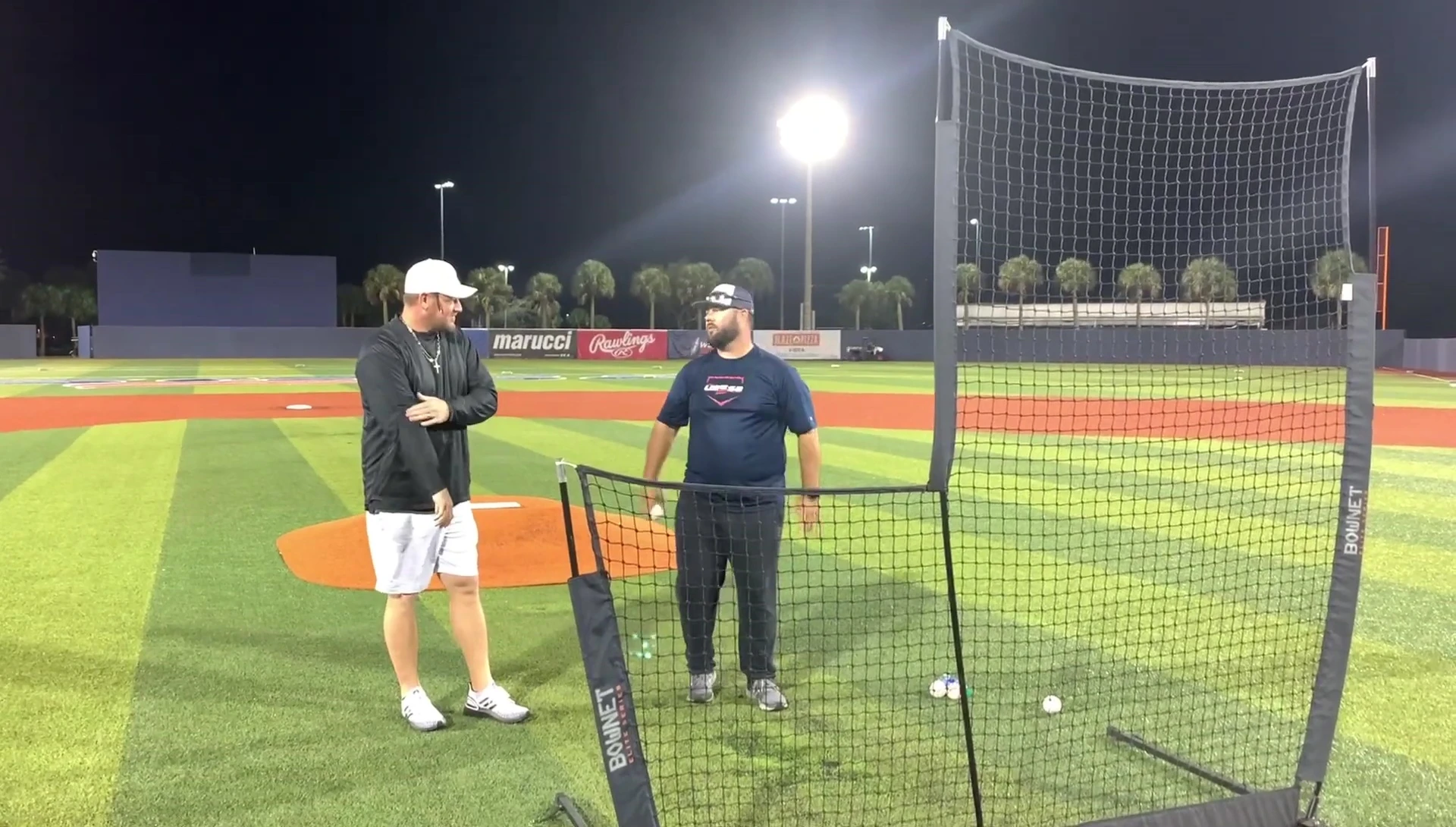 Coach demonstrating the use of a glove in his non-throwing hand.