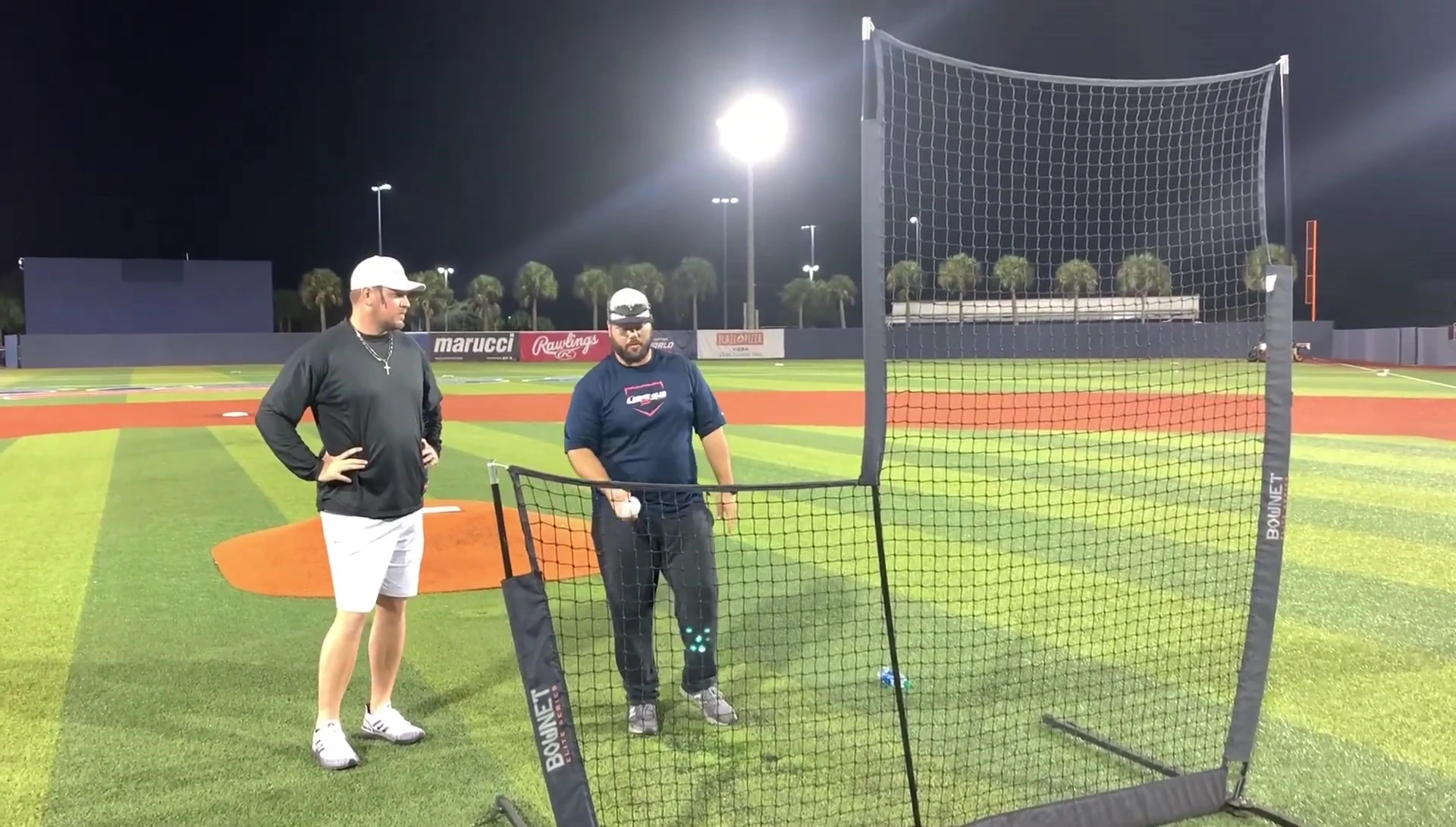 Coach demonstrating the soft toss technique.
