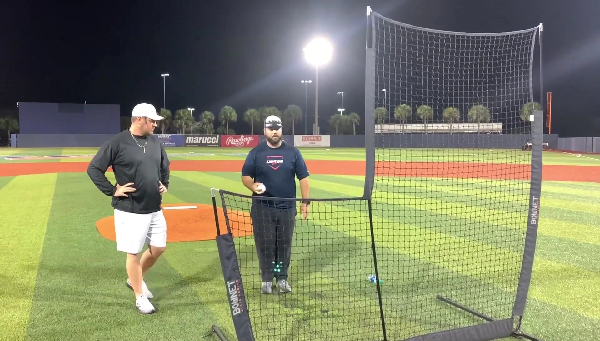 Coach demonstrating the stepping technique for soft toss.
