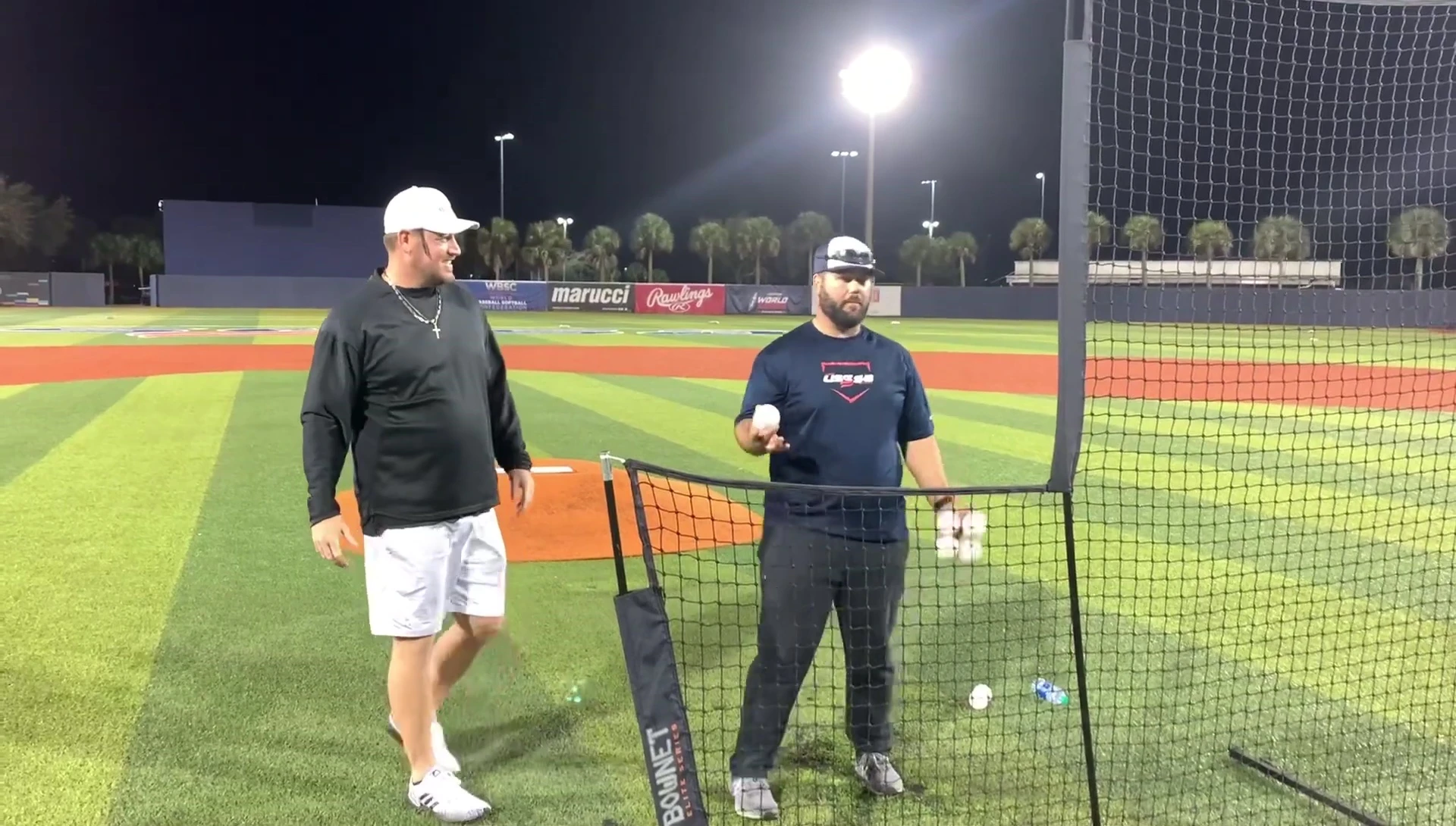 Coach demonstrating good throwing distance and stance.