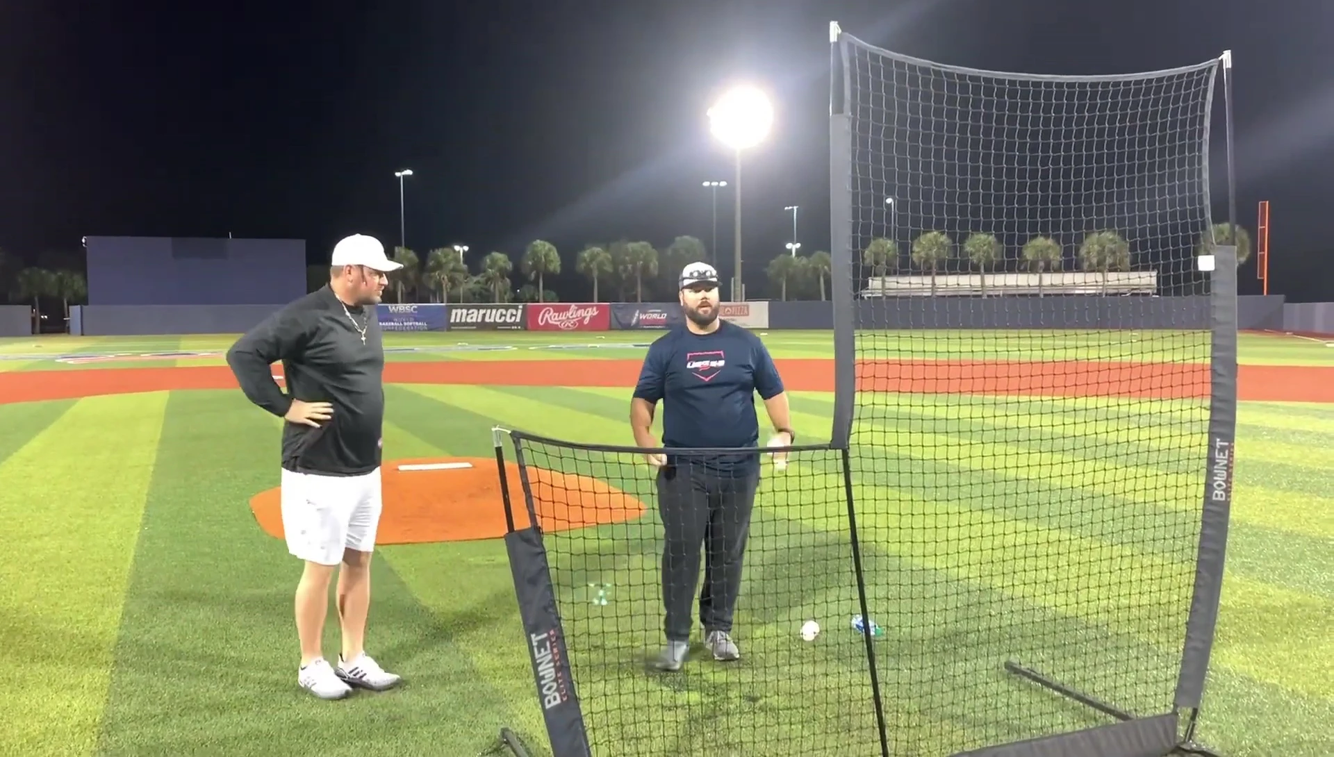 Coach demonstrating arm extension and proper mechanics.