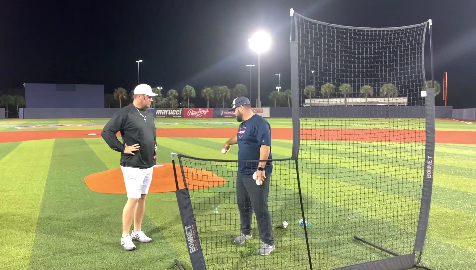 Coach emphasizing the importance of back-arm extension for reduced shoulder strain.