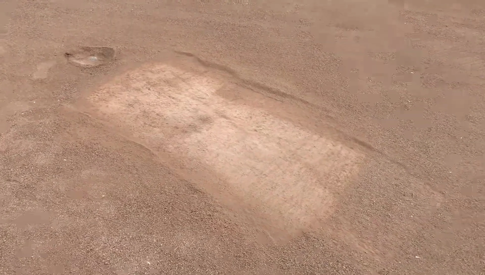 The hole forming near second base from player slides