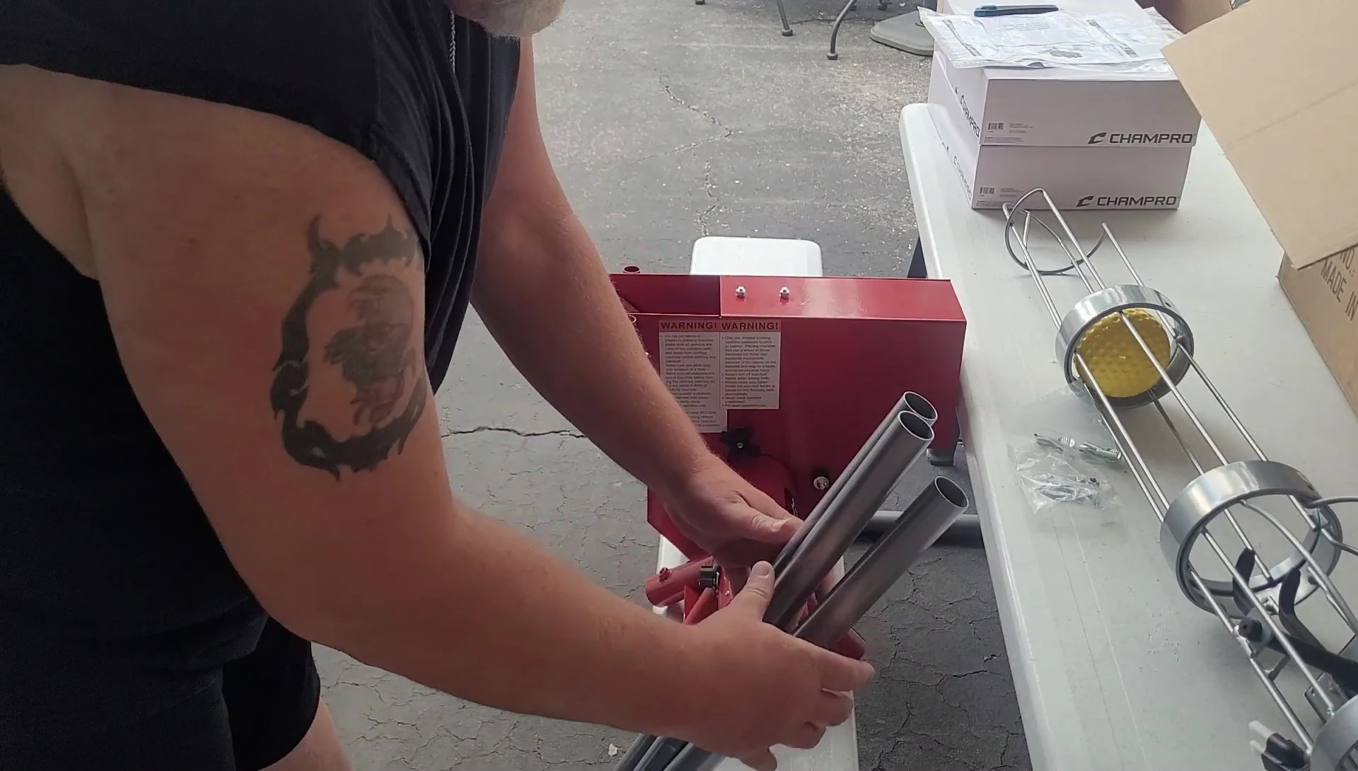 The user assembling the pitching machine.