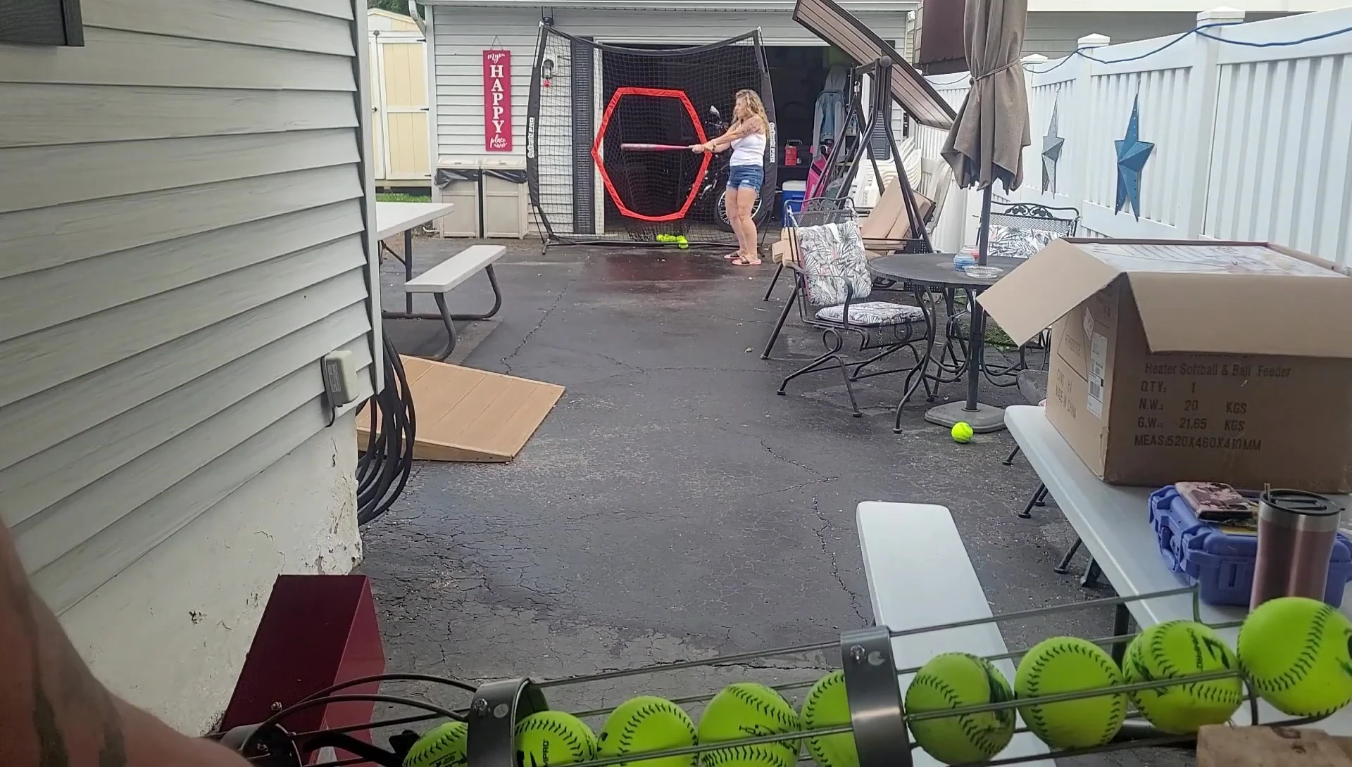 A person batting against the pitching machine.