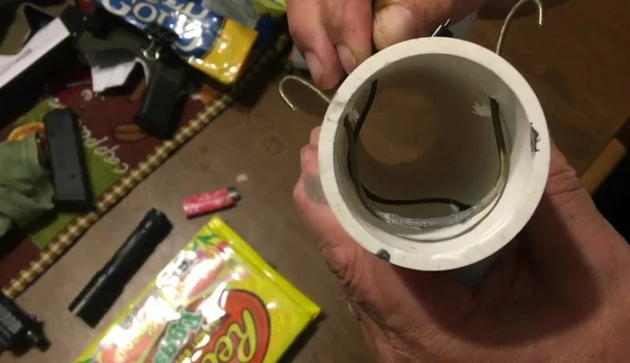 Pushing the zip tie to advance the next round into firing position.