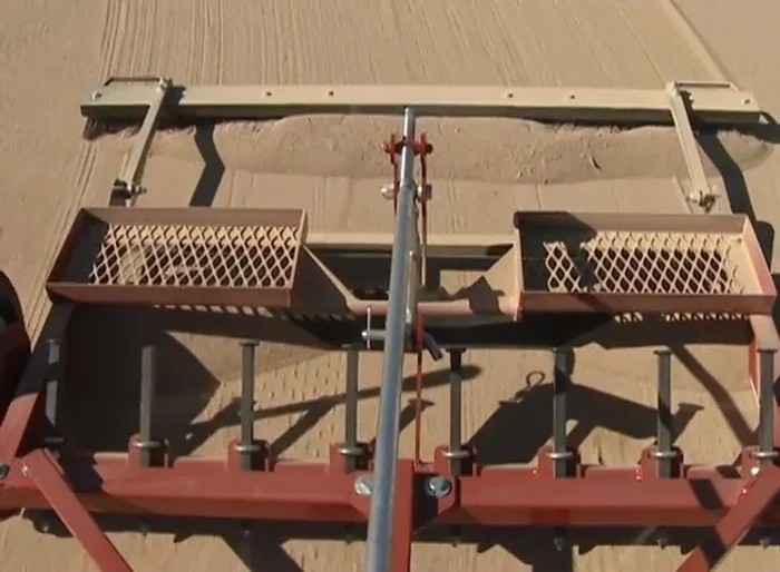 Groom the top layer of the playing field without damaging the base layer.