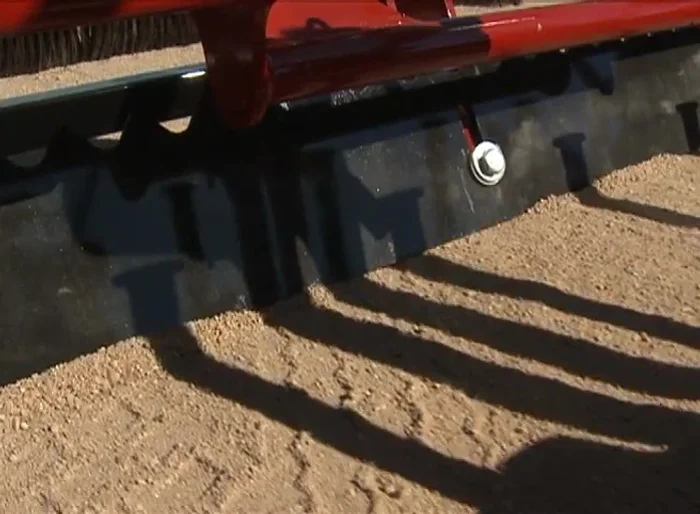 Groom the top layer of the playing field without damaging the base layer.