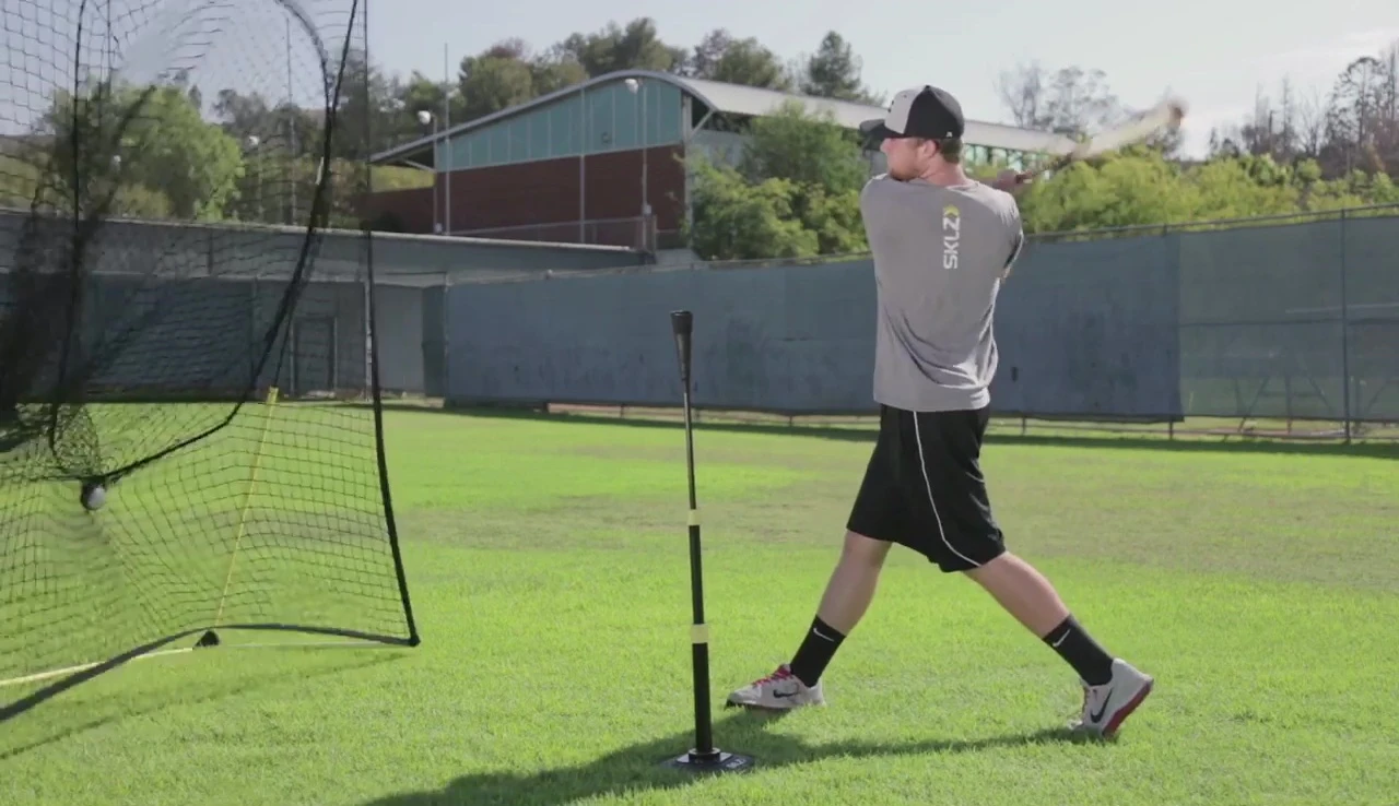 Batter demonstrating proper hand placement during a high tee drill.