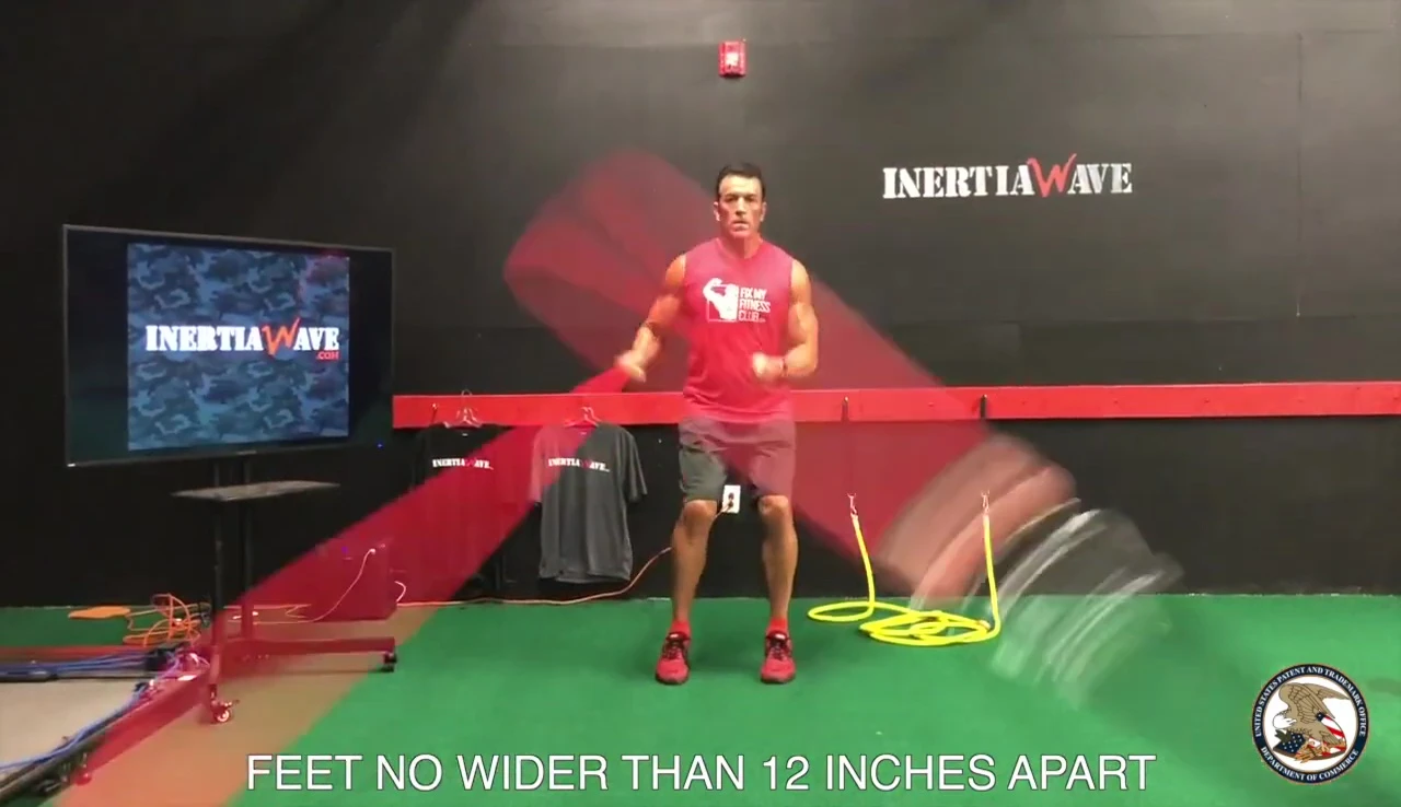 User demonstrating the advanced Double Over exercise with tubes crossing over each other