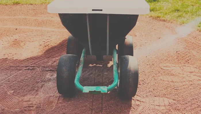 Use the Chalker to trace the lines of the batter's box and foul lines, following the template's impression.