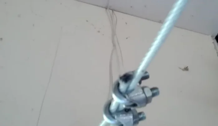 Bolt the eye hook securely into the wall joists, repeating on both ends.