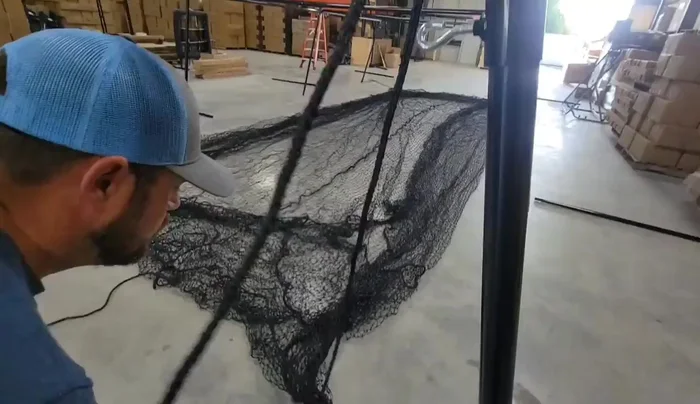 Tie the corner and center lead ropes to the frame fittings. Leave some slack; don't cinch completely. This allows the net to hang properly.