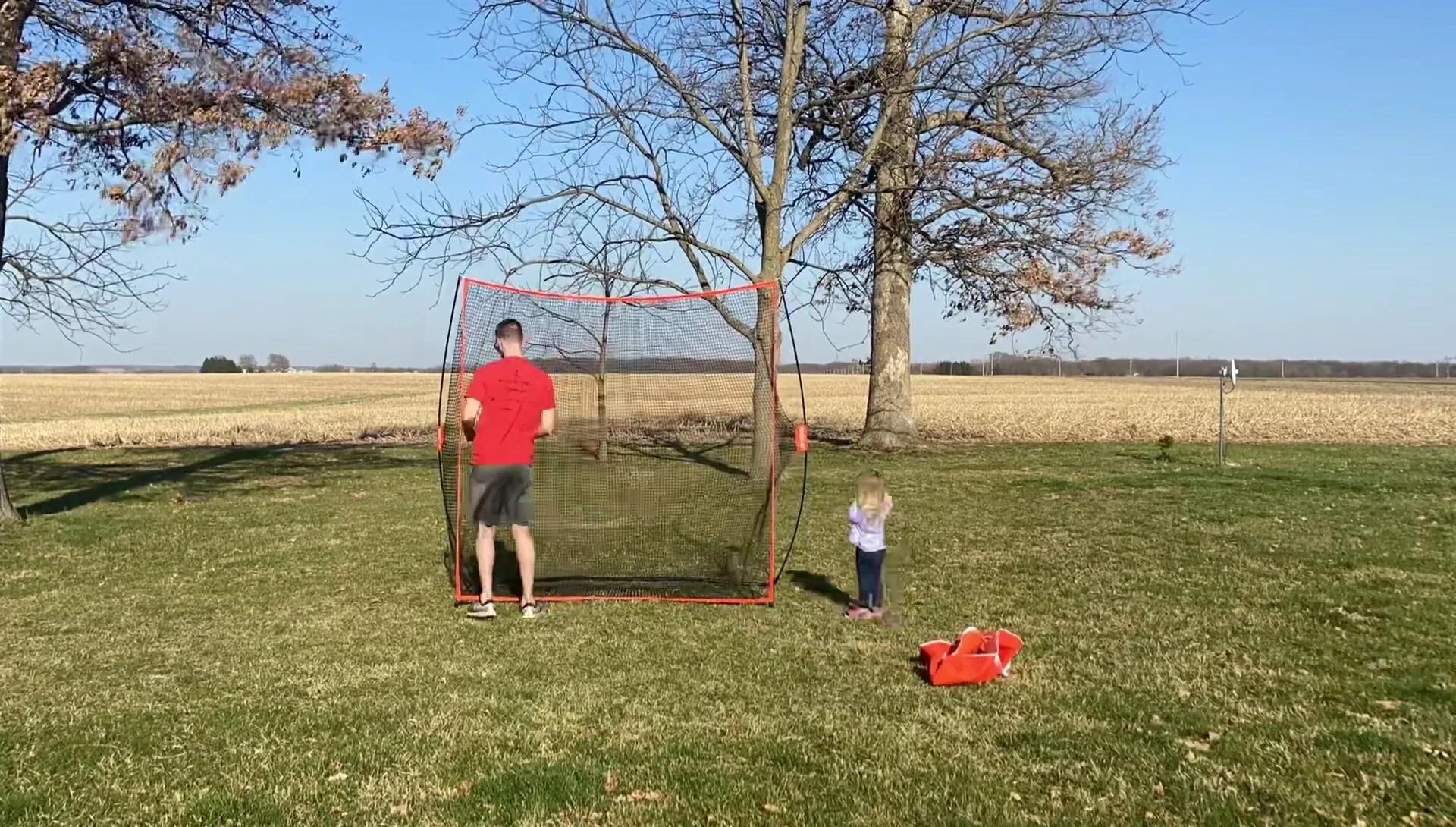 The golf net secured with stakes in the ground