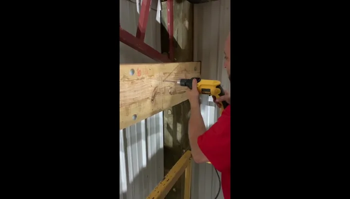 Attach the bracket to the header using lag screws and a ratchet.