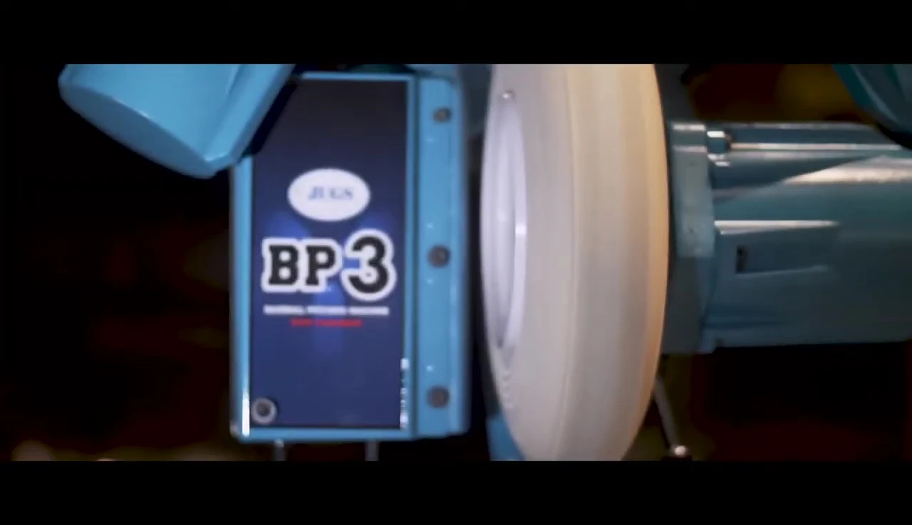 Close-up shot of the JUGS BP3 pitching machine in action.